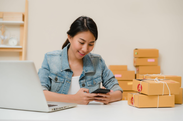 A young businesswoman checking her phone for orders.